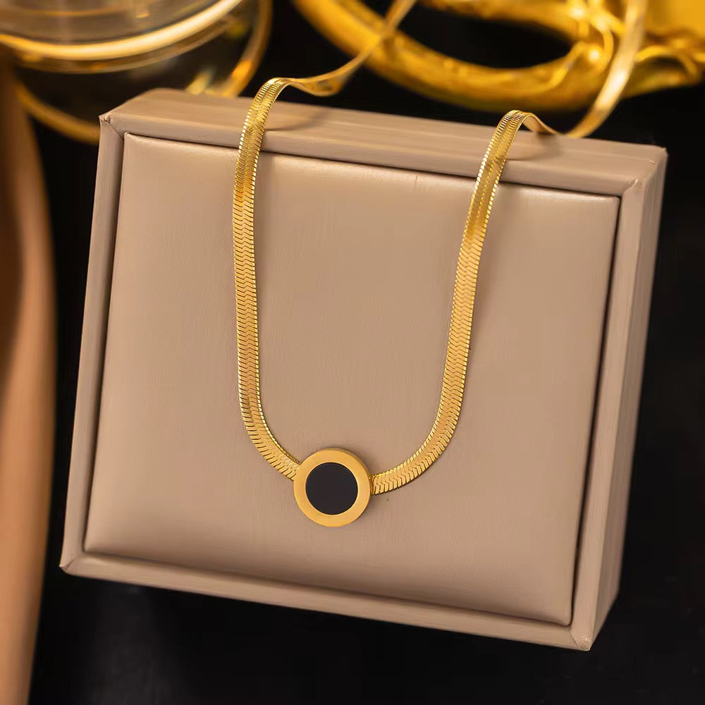 Elegant Gold Herringbone Chain Necklace with Black Enamel Circle Pendant